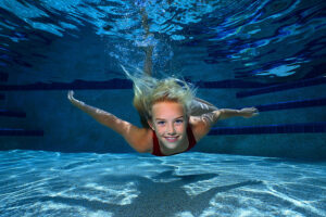 Young Girl Swimming Underwater